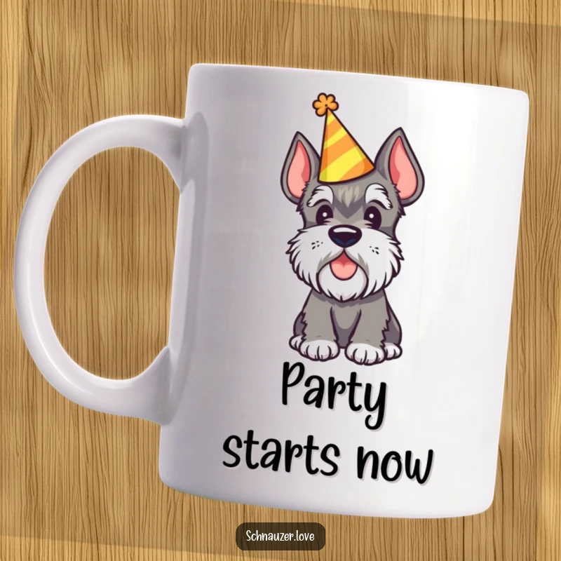 Funny Schnauzer Dog Mug showing a schnauzer wearing a party hat and tilting its head curiously, ready for celebration.