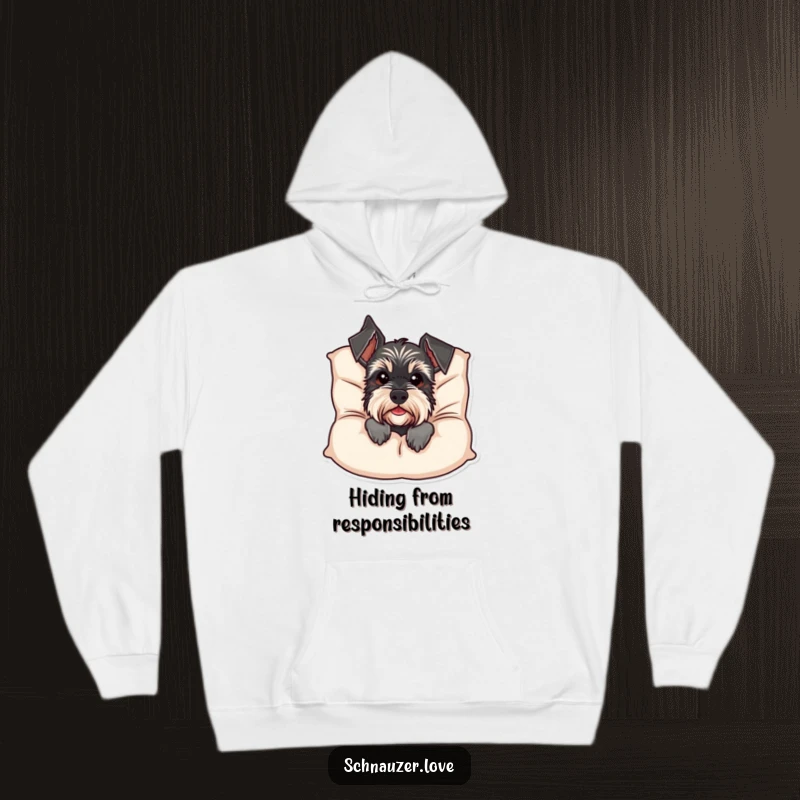 Funny Schnauzer Hoodie: A charming schnauzer playfully peeks from behind a fluffy cushion, bringing warmth and humor to this cozy apparel. Great funny gift idea.