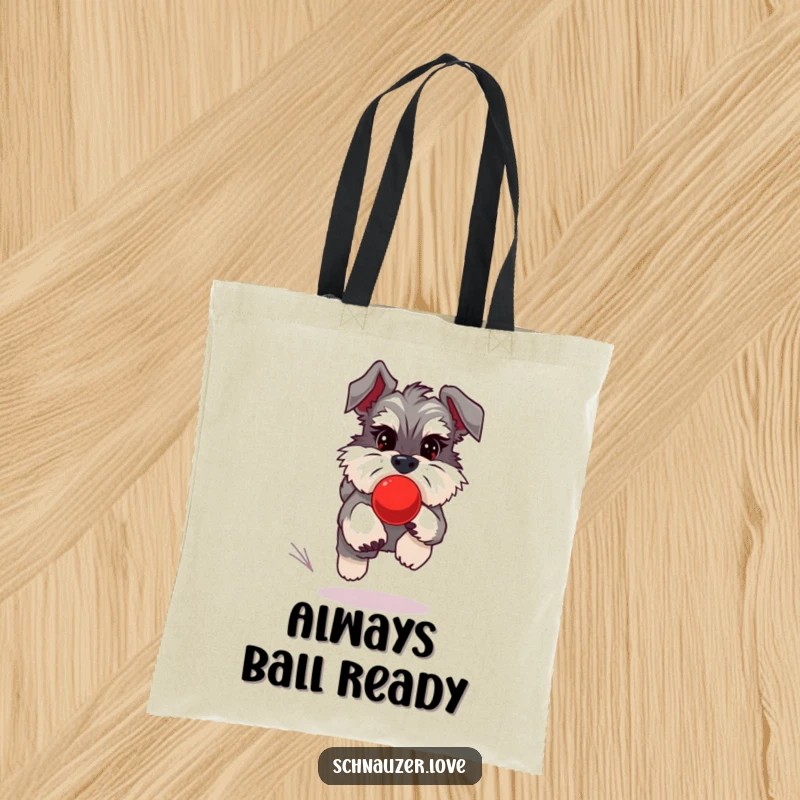 Funny Schnauzer Tote Bag depicting a schnauzer chasing a red bouncing ball, perfect for carrying essentials with style.