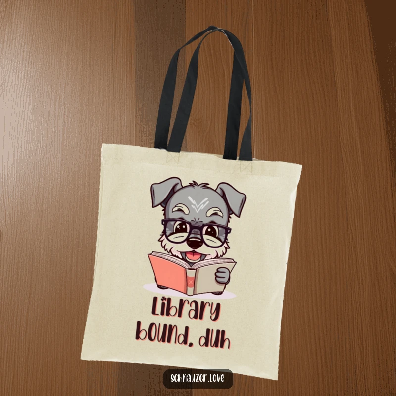 Funny Schnauzer tote bag featuring a dog in glasses reading a book, ideal for carrying literary treasures with sophisticated and humorous flair.